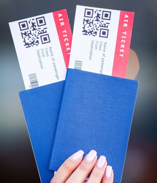 Passports and tickets for flight on hand of woman